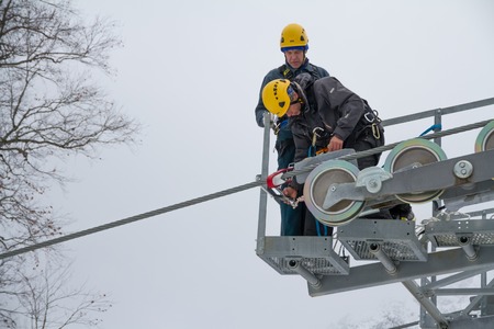 SOCHI, RUSSIA - DECEMBER 12, 2013: Workers repairing the ski lift in mountain resort Rosa Khutor.