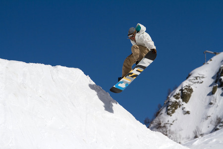 SOCHI, RUSSIA - MARCH 22, 2014: Snowboarder jumps in Snow Park,  mountain ski resort Rosa Khutor.のeditorial素材