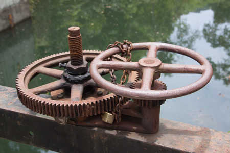 Irrigation Canal and old rusty Floodgate valveの写真素材
