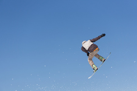 Snowboarder jumps in Snow Park, big airの写真素材