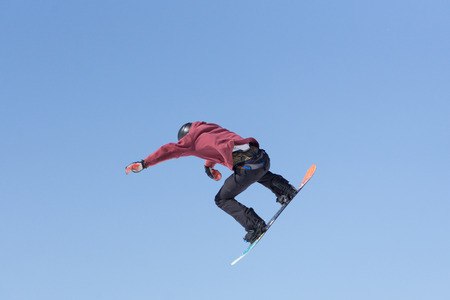 Snowboarder jumps in Snow Park, big airの写真素材