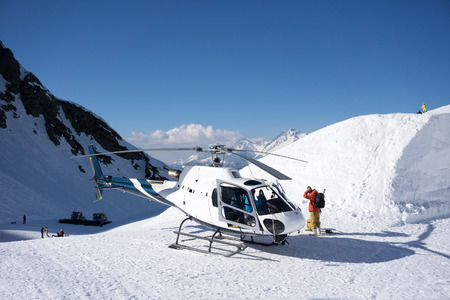 White rescue helicopter parked in the snowy mountainsの写真素材