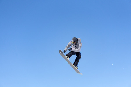 Snowboarder jumps in Snow Park, big airの写真素材