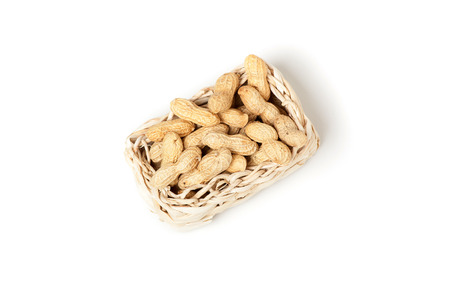 unshelled peanuts peanuts isolated in basket on white backgroundの写真素材