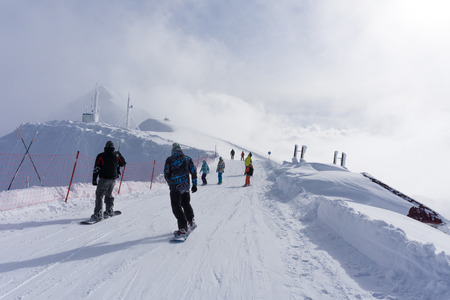 Skiers and snowboarders going down the slope at ski resort.のeditorial素材