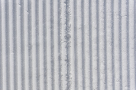 Fresh snow groomer tracks on a mountain ski piste, backgroundの写真素材