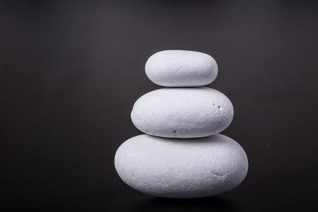 white pebbles on black backgroundの写真素材