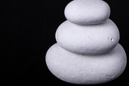 white pebbles on black backgroundの写真素材