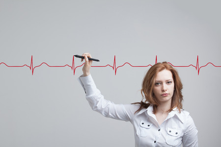 young doctor woman drawing cardiogram in air