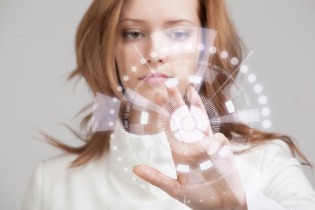 Future technology. Touch button interface. Woman working with futuristic interfaceの写真素材