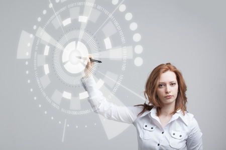 Future technology. Touch button interface. Woman working with futuristic interfaceの写真素材