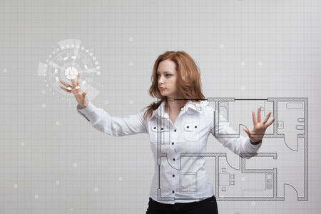 Young woman architect working with a virtual apartment planの写真素材