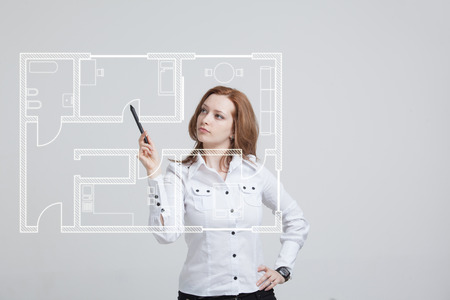 Young woman architect working with a virtual apartment planの写真素材