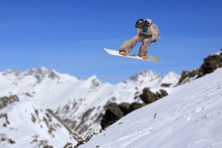 Flying snowboarder on mountains, extreme sportの写真素材