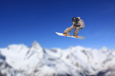 Flying snowboarder on mountains, extreme sportの写真素材