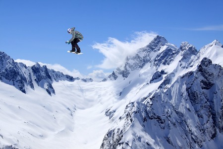 Flying snowboarder on mountains, extreme sportの写真素材