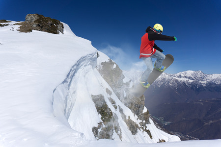 Flying snowboarder on mountains, extreme sportの写真素材