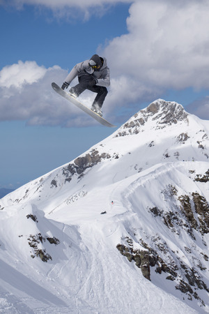 Flying snowboarder on mountains, extreme sportの写真素材
