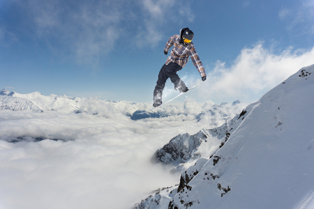 Flying snowboarder on mountains, extreme sportの写真素材