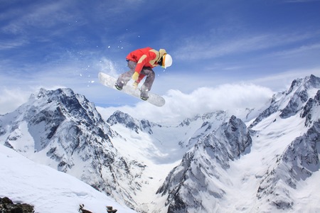 Flying snowboarder on mountains, extreme sportの写真素材