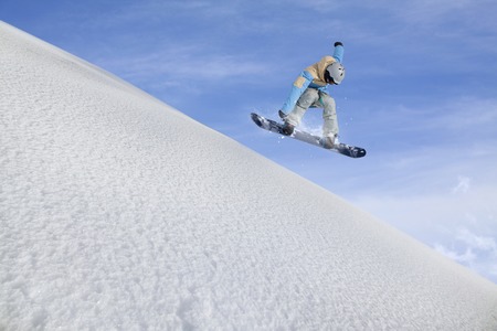 Flying snowboarder on mountains, extreme sportの写真素材