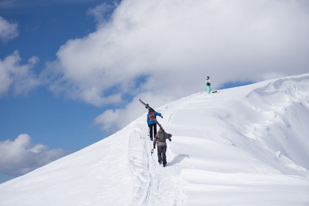 Skiers walking uphill for freeride, extreme sportの写真素材