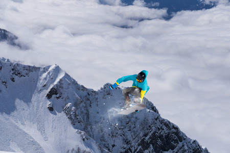 Flying snowboarder on mountains, extreme sport