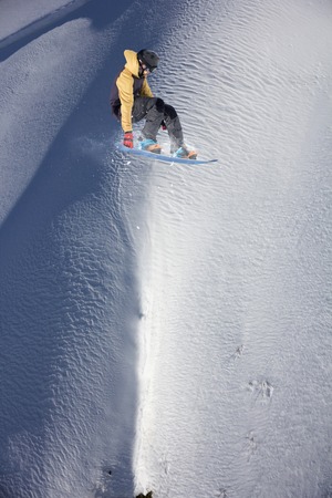 Flying snowboarder on mountains, extreme sport
