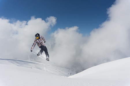 Flying snowboarder on mountains, extreme sportの写真素材