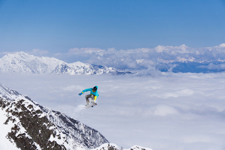 Flying skier on mountains, winter extreme sportの写真素材