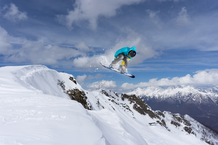 Flying snowboarder on mountains, extreme sportの写真素材