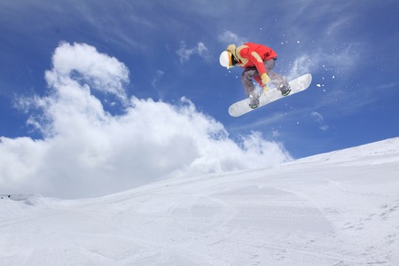 Flying snowboarder on mountains, extreme sportの写真素材