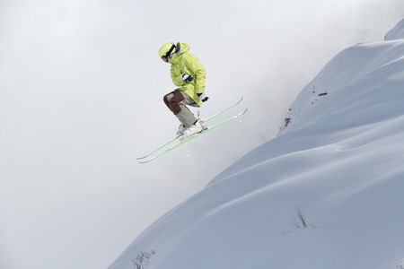 Flying skier on mountains, winter extreme sportの写真素材