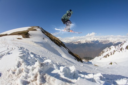 Flying skier on mountains, winter extreme sportの写真素材