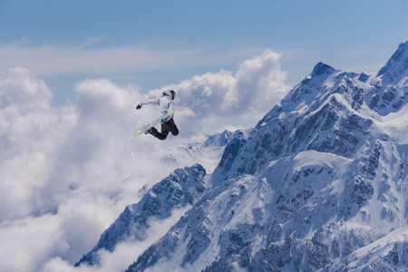 flying snowboarder on mountains. Extreme winter sportの写真素材