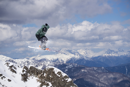 Flying skier on mountains, winter extreme sportの写真素材