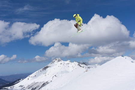 Flying skier on mountains. Extreme winter sport.の写真素材
