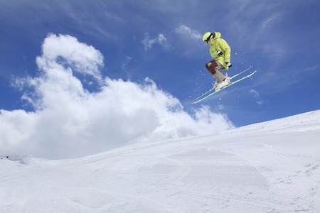 Flying skier on mountains. Extreme winter sport.の写真素材