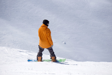 Snowboarder standing on top of mountain, winter extreme sportの写真素材