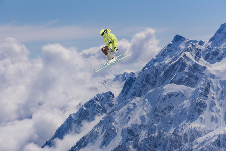 Flying skier on mountains. Extreme winter sport.の写真素材