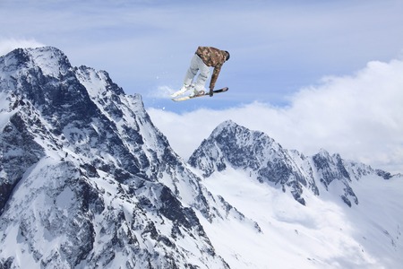 Flying skier on mountains. Extreme winter sport.
