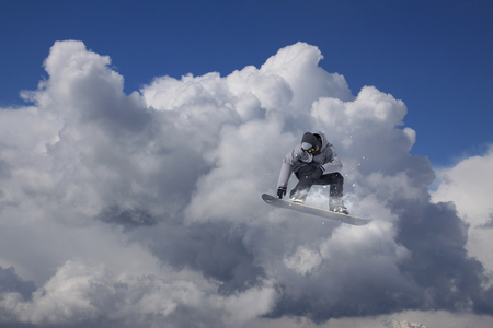 Flying snowboarder on mountains. Extreme winter sport.の写真素材