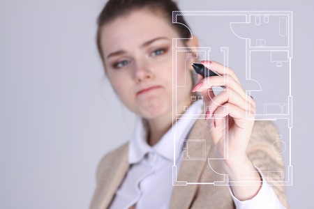 Young woman architect working with a virtual apartment planの写真素材