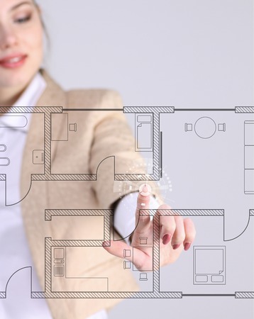 Young woman architect working with a virtual apartment planの写真素材