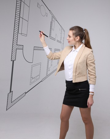 Young woman architect working with a virtual apartment planの写真素材