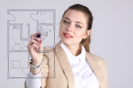 Young woman architect working with a virtual apartment planの写真素材