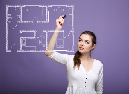 Young woman architect working with a virtual apartment planの写真素材