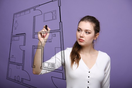 Young woman architect working with a virtual apartment planの写真素材