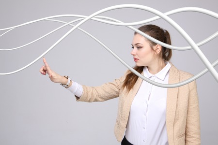 Young woman with electrical cables or wires, curved linesの写真素材