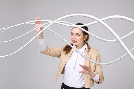 Young woman with electrical cables or wires, curved linesの写真素材